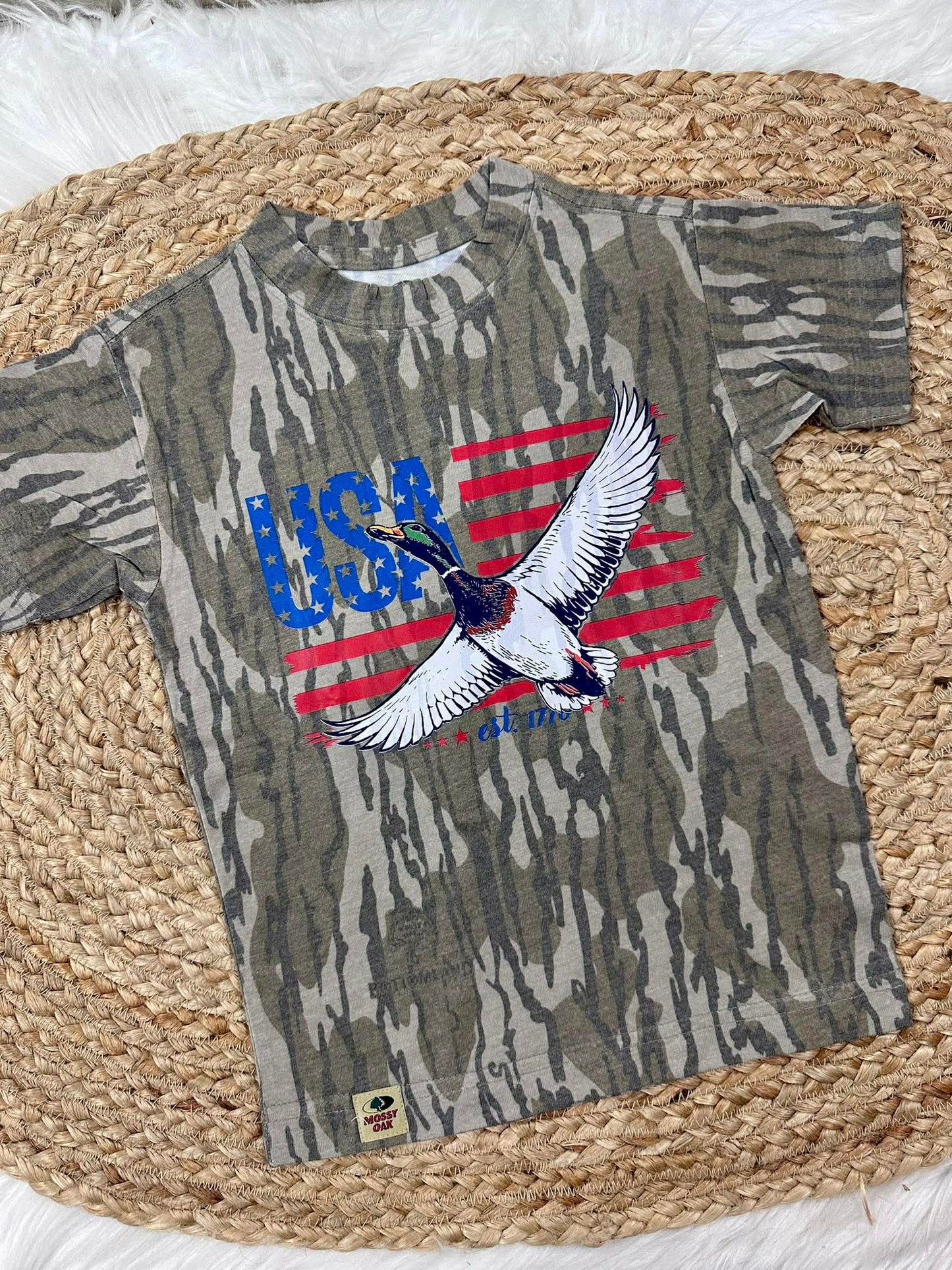 Camouflage t-shirt with USA and mallard duck like eagle design on a woven mat
